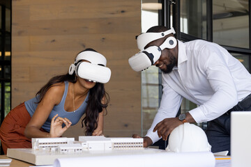 Diverse team of young colleagues using VR headsets for an architectural project
