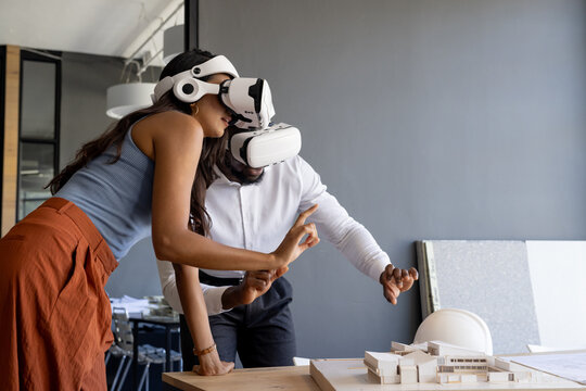 Diverse team working with virtual reality headsets in modern office, copy space