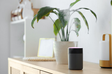 Air humidifier on commode in living room, closeup