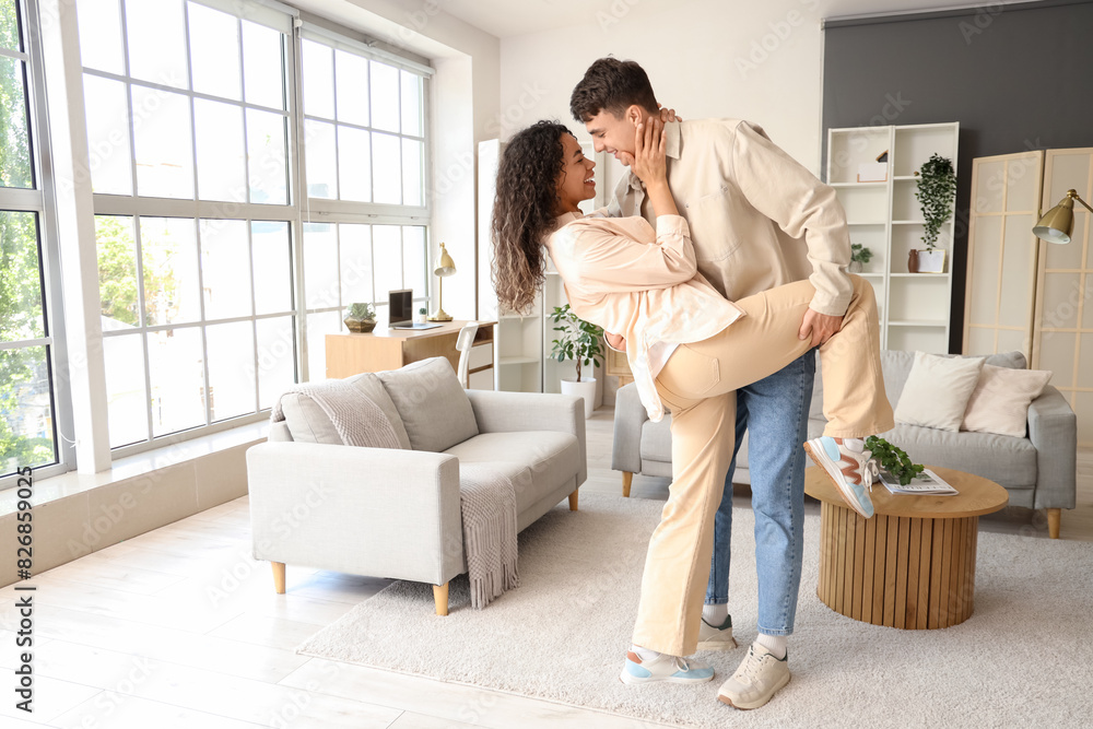 Poster Young couple in love dancing at home