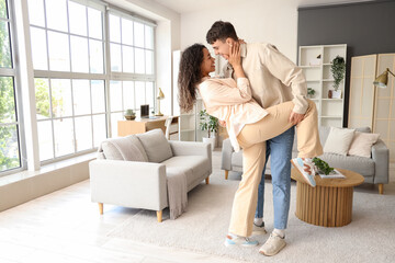 Young couple in love dancing at home