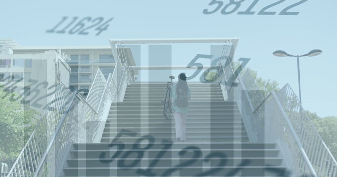 Image of changing numbers, graphs, rear view of man carrying bicycle while walking up stairs