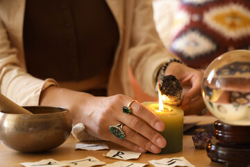 Young witch burning incense at home, closeup