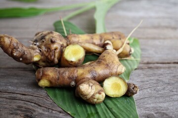 Turmeric root on wood background