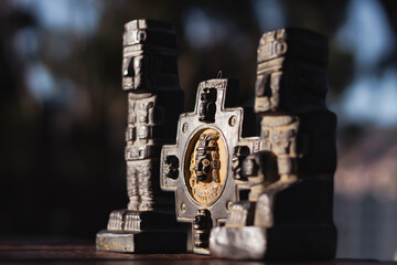 Miniatures of monoliths and the chakana, focus on the chakana with the inca, bokeh effect