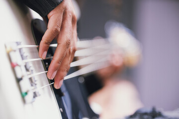 Hand, bass guitar and music in studio for process, mixing or rehearsal for performance. Person,...