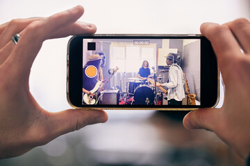 Recording, smartphone and garage band playing live music for internet concert, streaming or social...
