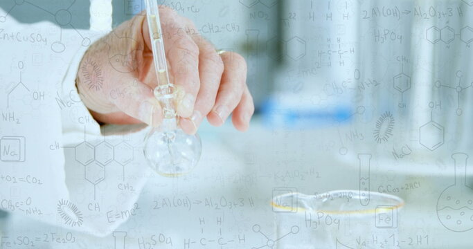 Caucasian senior male scientist holding flask, examining a clear liquid - Powered by Adobe