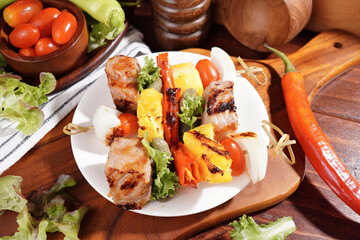 Barbecue grilled sliced ​​meat and vegetables on a wooden
