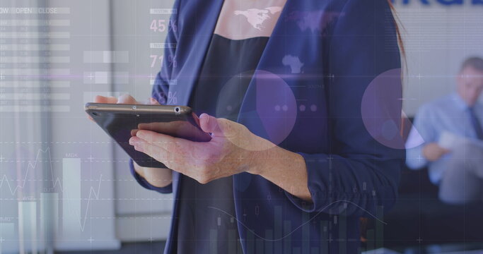 Middle-aged Caucasian woman holding tablet, displaying financial data