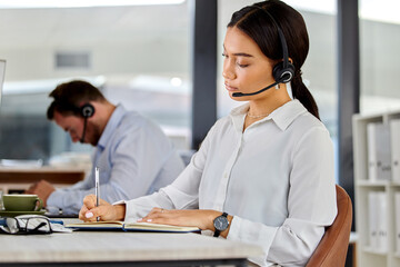 Call center, woman and book on table in office for customer service, notes and sales planning....