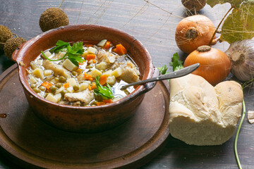 Hake with potatoes , beans , carrots , and parsley , on the pot