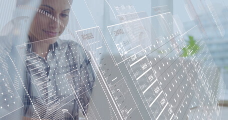 Image of financial data processing over caucasian businesswoman using laptop in office