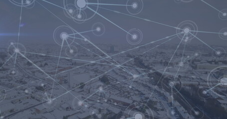 Image of network of connections against aerial view of winter landscape