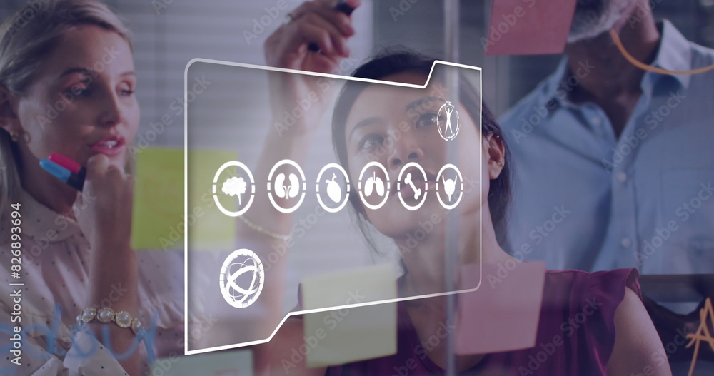 Poster image of multiple digital icons against diverse colleagues discussing over memo notes at office