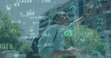 Image of globe of digital icons over biracial man using smartphone and hailing a taxi on street