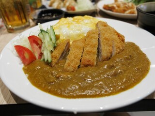 Fried Pork Curry Rice with Omelette on white plate