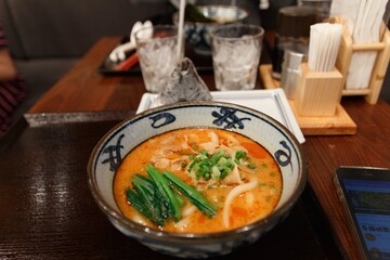 Japanese spicy udon ramen with glass of water