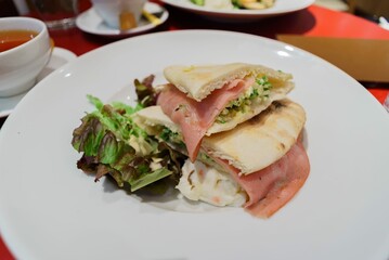 sandwich with ham and cheese vegetable and salad
