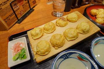 Akashiyaki with soup stock in wooden plate