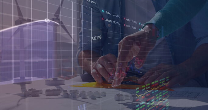 Image of trading boards, caucasian engineers sharing ideas on 3d model of windmills and houses