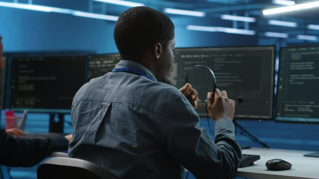 IT support expert in server room talking on headphones with admin about equipment storing datasets. Employee remotely chatting with specialist to mend data center racks doing computational operations