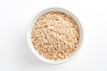 Top view of a bowl of rolled oats on a white background.  The oats are light brown and have a rough texture. They are a good source of fiber and nutrients.