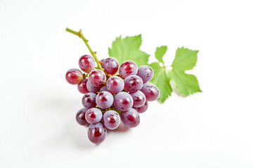 Fototapeta premium A bunch of red grapes with green leaves on a white background.