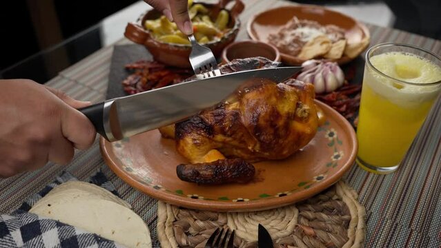Cutting wood-roasted chicken with a knife