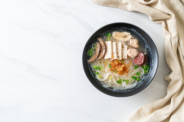 Vietnamese Rice Noodles Soup with Vietnamese Sausage served vegetables and crispy onion