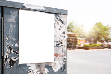 Mockup white paper or white sticker poster displayed on a sidewalk wall. Promotion information for...