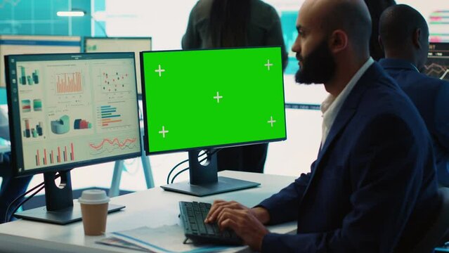 Chief financial officer reviews cost and revenue numbers next to a greenscreen, working on data management study for future improvement. Accountant ensures organizational success. Camera A.