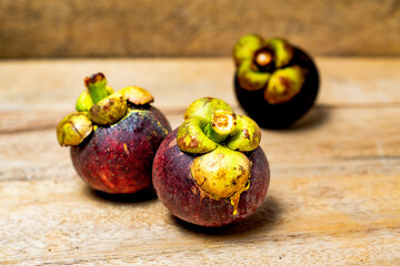 Mangosteen fruit isolated on wooden background. Mangosteen is known as a fruit that has very high levels of antioxidants. Garcinia mangostana