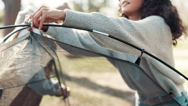Camping, tie and woman with tent setup for shelter for holiday, vacation and adventure outdoors. Travel, campsite and person with rope for pegs in forest, nature and woods to relax in countryside