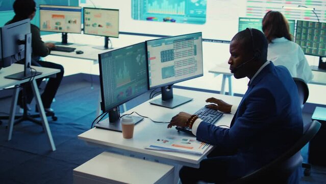 General director examining statistics big data on computer in a control room, makes a briefing report. Business manager studying sales numbers to adapt within market conditions. Camera B.
