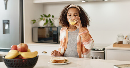 Child, home and drinking orange juice or lunch meal or healthy sandwich, vitamin c or fiber. Girl,...