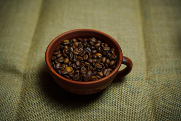 Coffee beans in a clay mug
