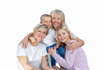 Several generations of women in a family hug and laugh with a little boy. Love and tenderness....