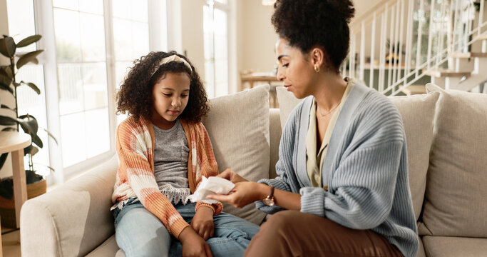 Sanitary, towel and pad with mom for menstruation knowledge for girl child, explain and awareness for growth or development. Mother, kid and together on sofa for hygiene education reproductive health