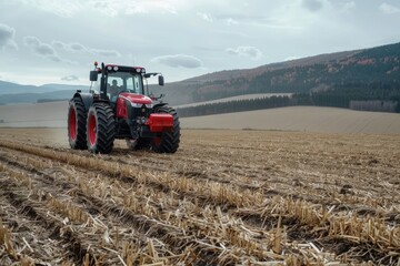 Fototapeta premium Modern tractor working on a vast agricultural field