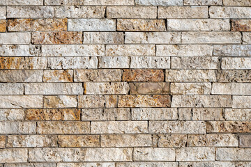 Background from a wall of beige and brown clinker bricks
