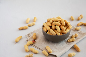 Organic Raw Peanuts in a Bowl, side view. Copy space.