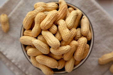 Organic Raw Peanuts in a Bowl, top view.