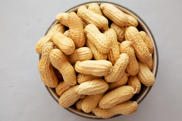 Organic Raw Peanuts in a Bowl, top view.