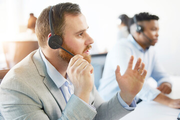 Man, listening and call centre with microphone in office for support, customer with faq in Europe....