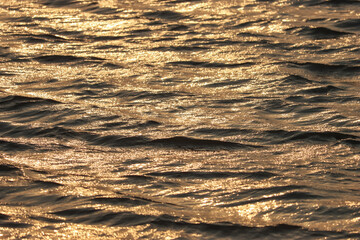 Sunlight reflection on the river waves at the sunset 