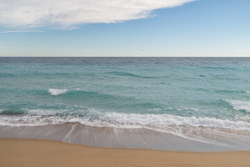 Empty sand beach on Mediterranean sea with horizon line vacation background