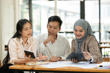 Asian businessmen, women and men Talk about new projects, presents at home office.