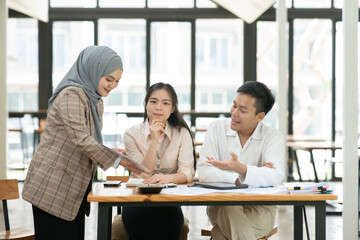 Asian businessmen, women and men Talk about new projects, presents at home office.