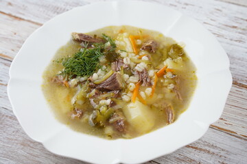 Soup with beef meat, pickled cucumbers and pearl barley.  Rassolnik- traditional Russian cuisine cucumber soup